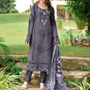 Elegant woman wearing charcoal grey embroidered 3-piece suit with floral printed dupatta, standing in a lush garden – The Elegance Corner